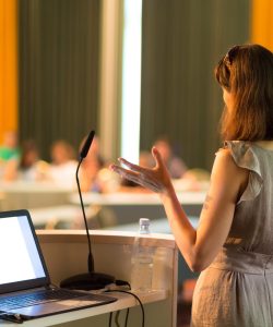 Female speaker at Business Conference and Presentation. Audience at the conference hall. Business and Entrepreneurship. Business woman. Horizontal composition.