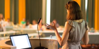 Female speaker at Business Conference and Presentation. Audience at the conference hall. Business and Entrepreneurship. Business woman. Horizontal composition.